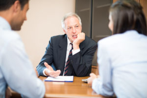 A lawyer discussing probate litigation with his clients in Michigan.